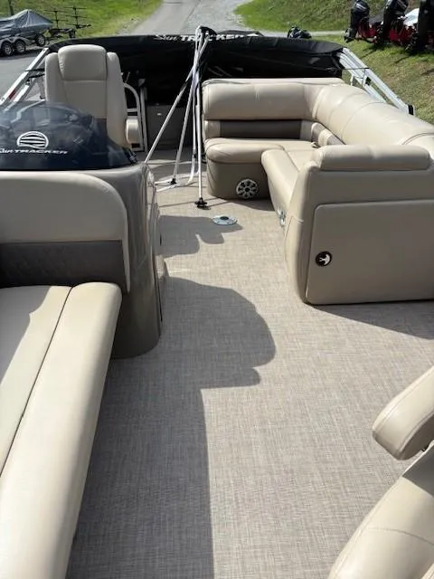 Slide: The Image of 2023 Sun Tracker SportFish 20 DLX interior with beige seating and spacious layout. - 10