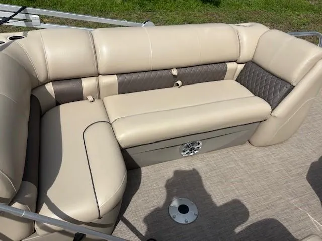 Slide: The Image of 2023 Sun Tracker SportFish 20 DLX boat interior with beige seating and storage compartment. - 7