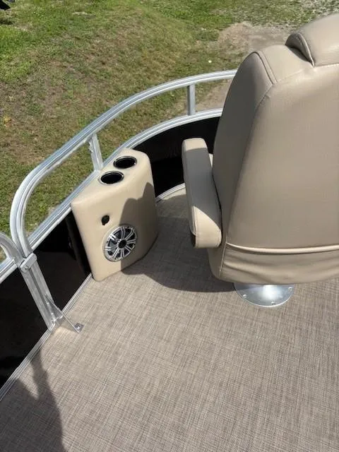 Slide: The Image of 2023 Sun Tracker SportFish 20 DLX boat interior with beige seating and speaker system. - 8