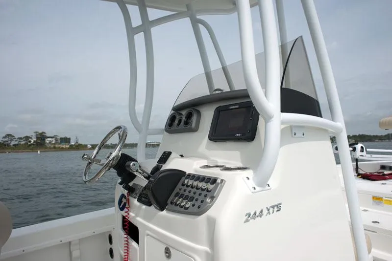 Slide: The Image of Manufacturer Provided Image: 2014 NauticStar 244 XTS boat console with steering wheel and navigation system. - 10