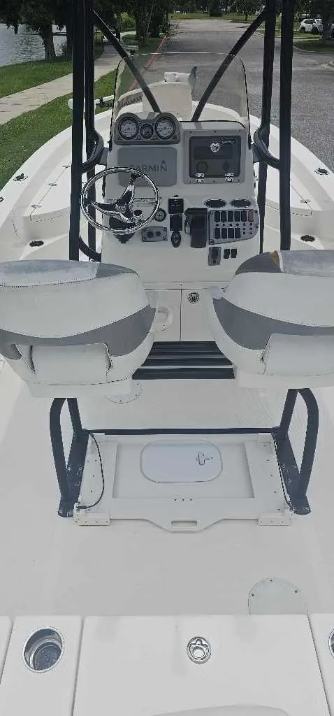 Slide: The Image of 2014 NauticStar 244 XTS boat interior with dual seats and control panel. - 4