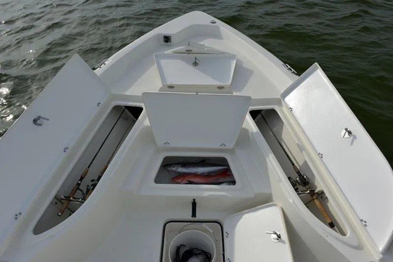 Slide: The Image of Manufacturer Provided Image: 2014 NauticStar 244 XTS boat with open storage compartments and fish in the cooler. - 8