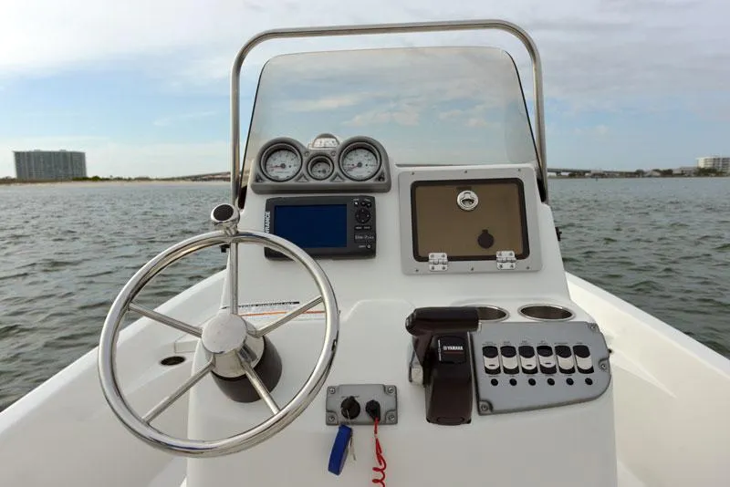 Slide: The Image of Manufacturer Provided Image: 2014 NauticStar 244 XTS boat console with steering wheel and navigation controls. - 9