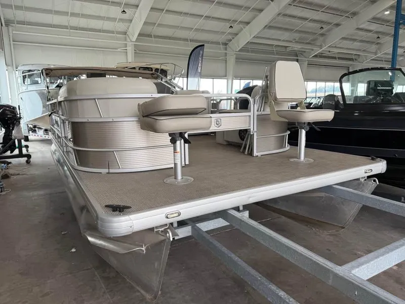 Slide: The Image of 2020 Godfrey SR 226 BF pontoon boat in a showroom, featuring dual fishing seats. - 0