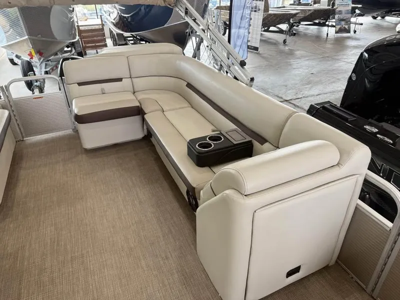 Slide: The Image of Luxurious seating on a 2020 Godfrey SR 226 BF boat, featuring beige upholstery and cup holders. - 12