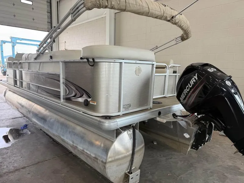 Slide: The Image of 2020 Godfrey SR 226 BF pontoon boat with Mercury 60 outboard motor in a garage. - 4