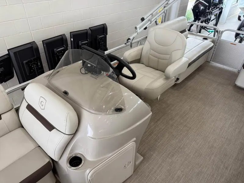 Slide: The Image of 2020 Godfrey SR 226 BF boat interior with beige seating and steering console. - 8