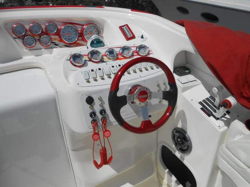 Slide: The Image of 2007 Sunsation 32 SS boat dashboard with red accents and multiple gauges. - 10