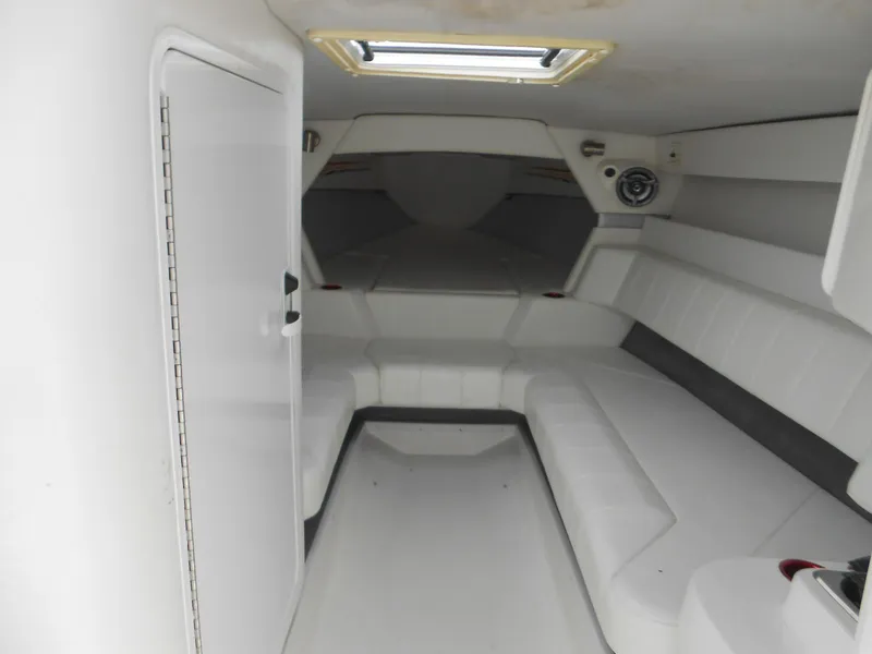 Slide: The Image of 2007 Sunsation 32 SS boat interior with white seating and overhead hatch. - 11