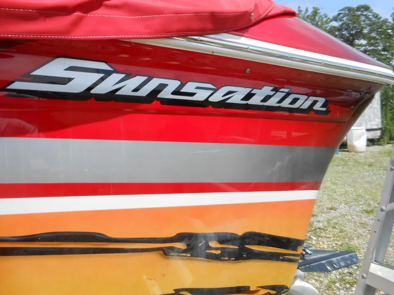 Slide: The Image of 2007 Sunsation 32 SS boat with vibrant red and orange design. - 4