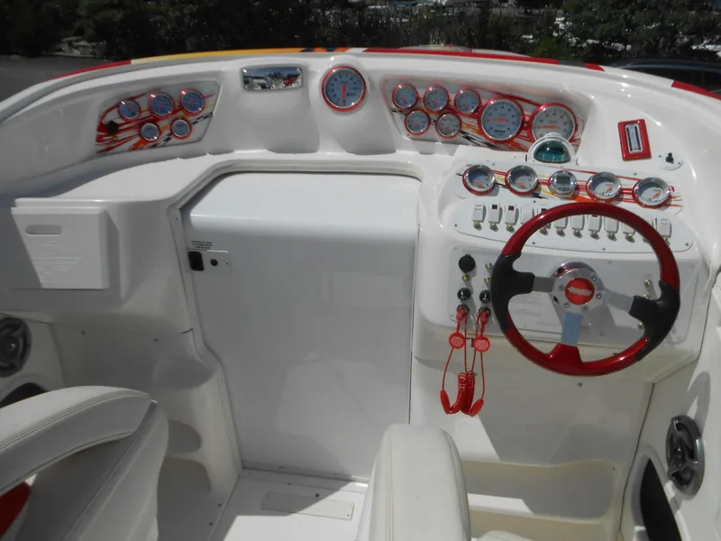 Slide: The Image of 2007 Sunsation 32 SS boat dashboard with gauges and red accents. - 9