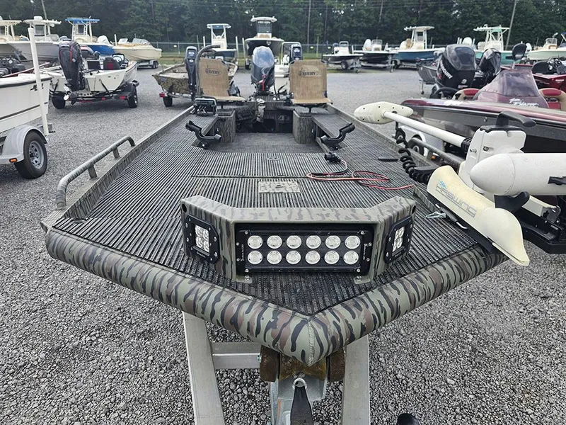 Slide: The Image of 2023 Low Country Swamp Fox 1854 boat with camouflage design and LED lights in a marina. - 4
