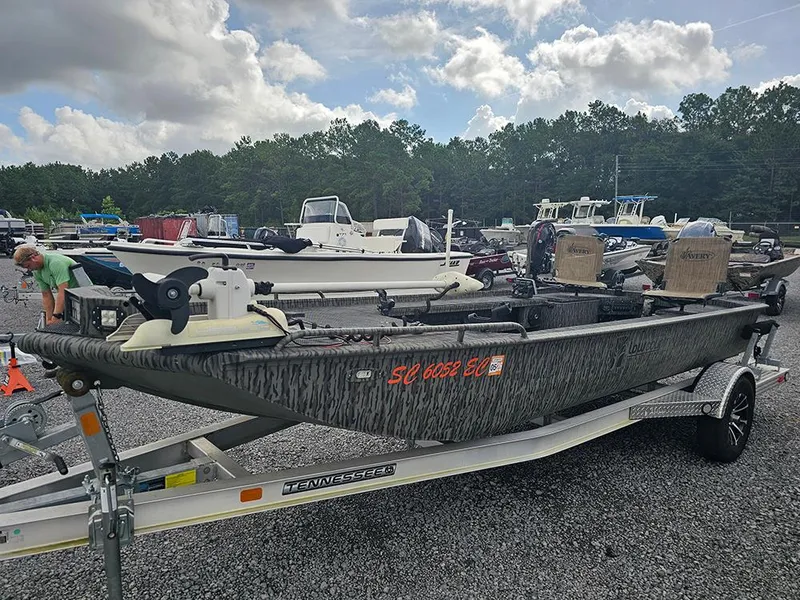 Slide: The Image of 2023 Low Country Swamp Fox 1854 boat on trailer in outdoor lot. - 5