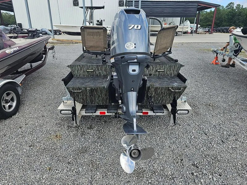 Slide: The Image of 2023 Low Country Swamp Fox 1854 boat with Yamaha 70 outboard motor, parked on gravel. - 7