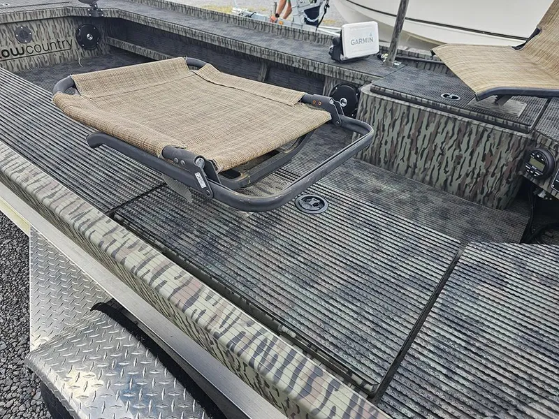 Slide: The Image of 2023 Low Country Swamp Fox 1854 boat interior with camouflage design and seating. - 8