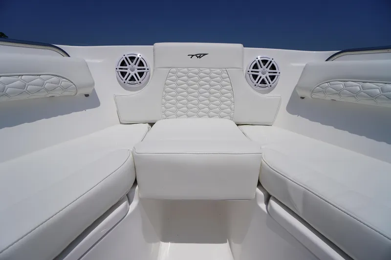 Slide: The Image of 2026 Tidewater 232 LXF boat interior with white cushioned seating and speakers. - 10