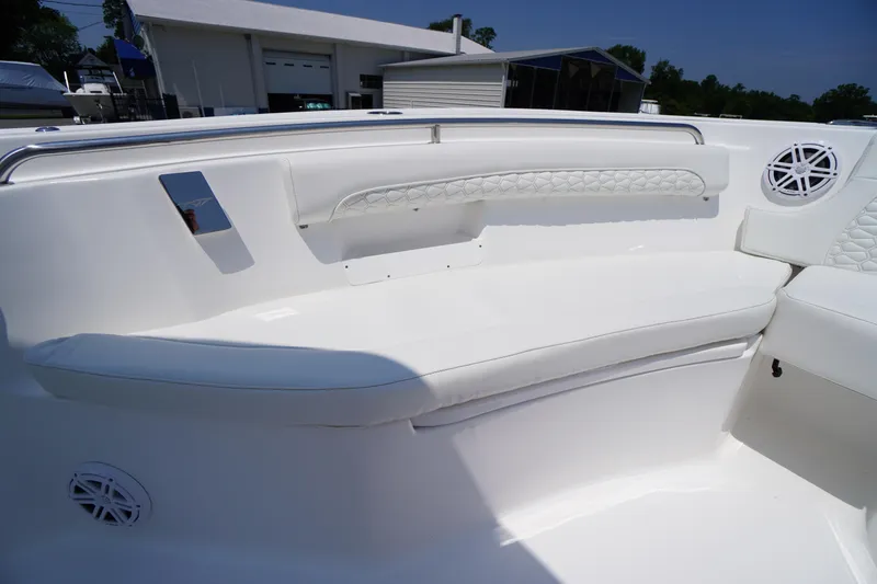 Slide: The Image of 2026 Tidewater 232 LXF boat interior with white cushioned seating and speaker. - 11