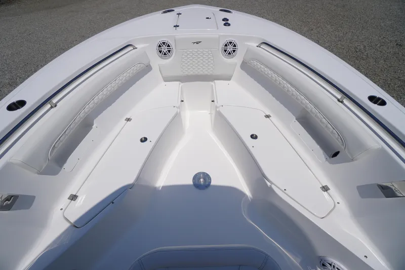 Slide: The Image of 2026 Tidewater 232 LXF boat interior with white seating and storage compartments. - 16