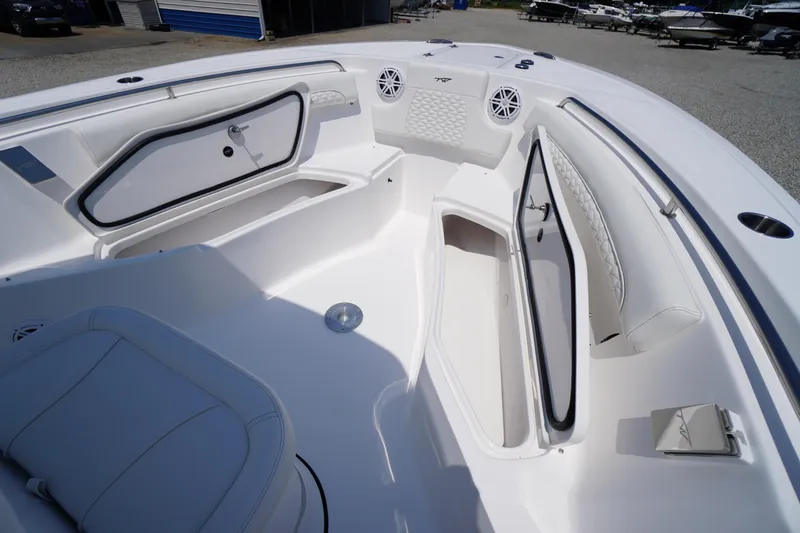 Slide: The Image of 2026 Tidewater 232 LXF boat interior with open storage compartments and cushioned seating. - 17