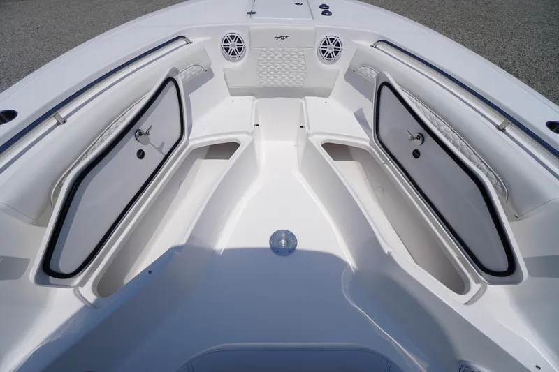 Slide: The Image of 2026 Tidewater 232 LXF boat interior with open storage compartments and sleek design. - 18