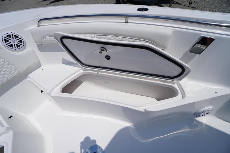 Slide: The Image of 2026 Tidewater 232 LXF boat storage compartment with open hatch and speaker. - 20