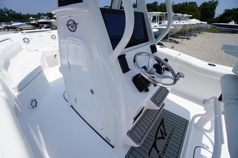 Slide: The Image of 2026 Tidewater 232 LXF boat interior with steering wheel and control panel. - 27