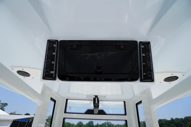 Slide: The Image of 2026 Tidewater 232 LXF boat console with control panel and storage compartment. - 33