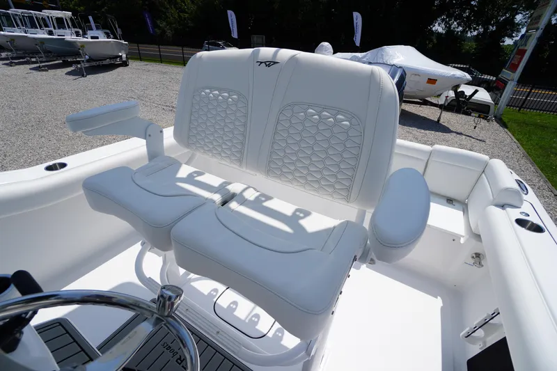 Slide: The Image of 2026 Tidewater 232 LXF boat interior with white cushioned seating and steering wheel. - 34
