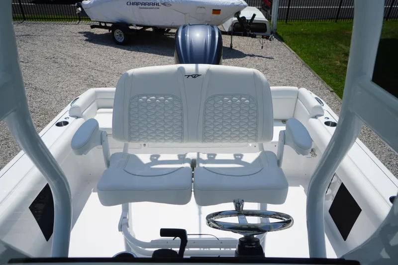 Slide: The Image of 2026 Tidewater 232 LXF boat interior with dual white seats and steering wheel. - 35