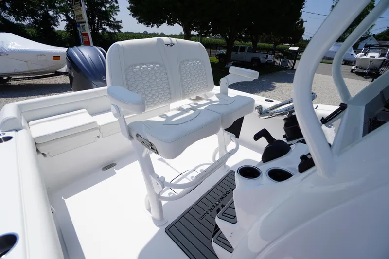 Slide: The Image of 2026 Tidewater 232 LXF boat interior with white seating and steering console. - 37