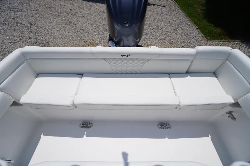 Slide: The Image of 2026 Tidewater 232 LXF boat with white cushioned seating and outboard motor. - 43