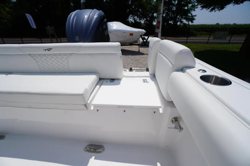 Slide: The Image of 2026 Tidewater 232 LXF boat interior with white seating and cup holder. - 46