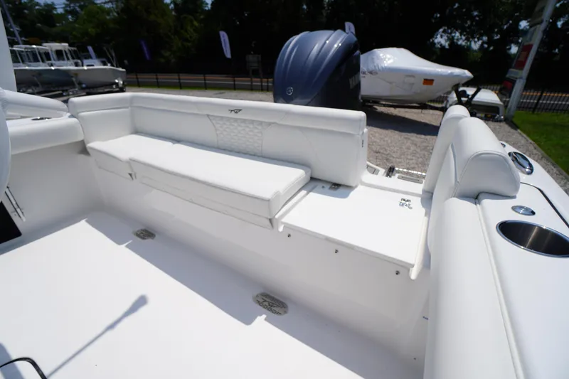 Slide: The Image of 2026 Tidewater 232 LXF boat interior with white seating and cup holders. - 47
