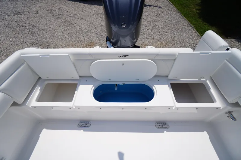 Slide: The Image of 2026 Tidewater 232 LXF boat interior with storage compartments and engine view. - 49