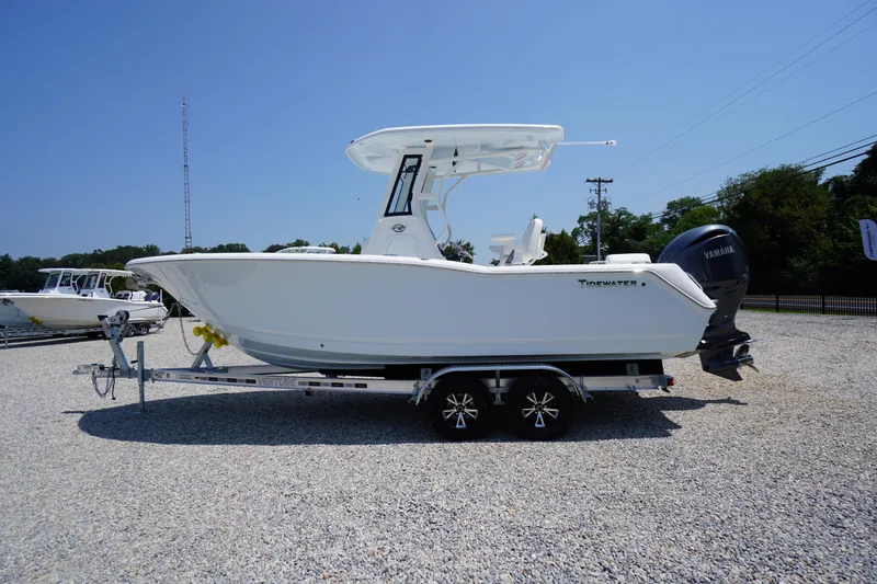 Slide: The Image of 2026 Tidewater 232 LXF boat on trailer, side view, clear sky background. - 72