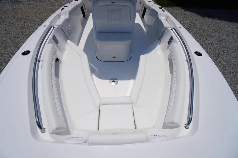 Slide: The Image of 2026 Tidewater 232 LXF boat interior with white seating and stainless steel railings. - 8