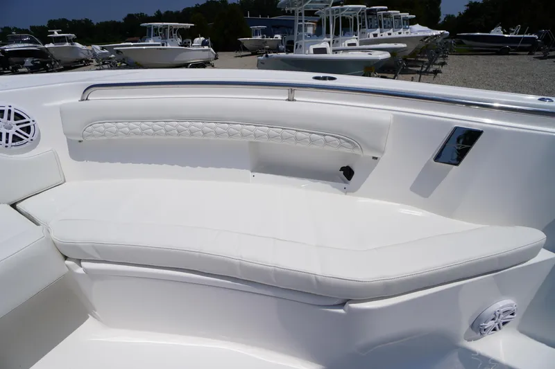 Slide: The Image of 2026 Tidewater 232 LXF boat interior with white cushioned seating and speaker. - 9