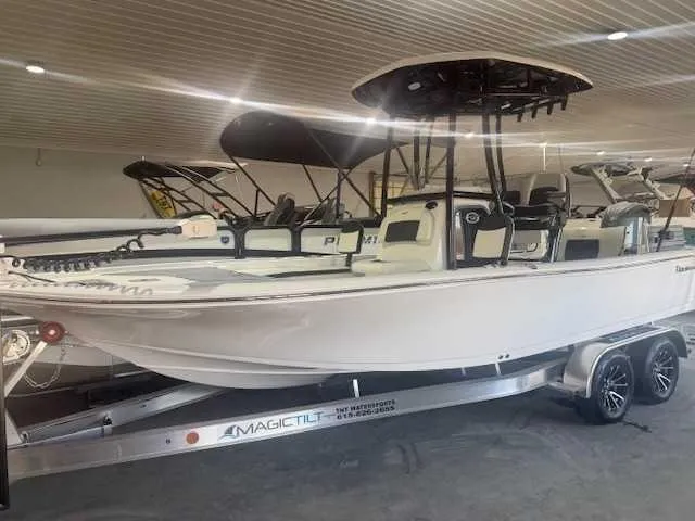 Slide: The Image of 2024 Tidewater 2210CB boat on Magic Tilt trailer in showroom. - 1