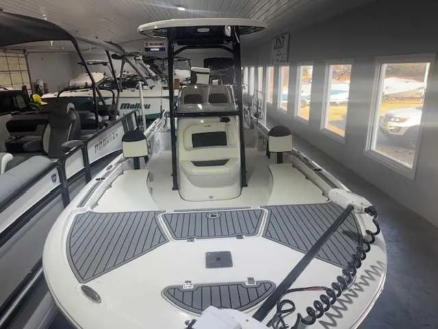 Slide: The Image of 2024 Tidewater 2210CB boat displayed in a showroom with sleek design and modern features. - 10