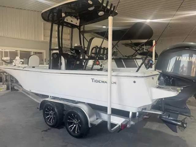 Slide: The Image of 2024 Tidewater 2210CB boat on trailer in indoor showroom, featuring Yamaha outboard motor. - 12