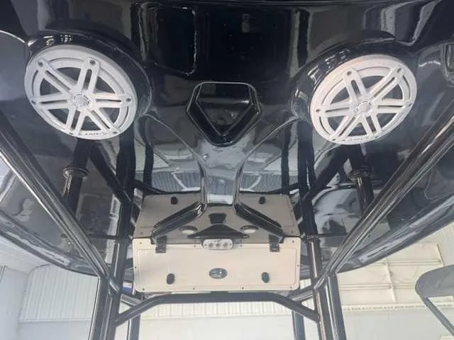 Slide: The Image of 2024 Tidewater 2210CB boat with dual overhead speakers and sleek black interior. - 4