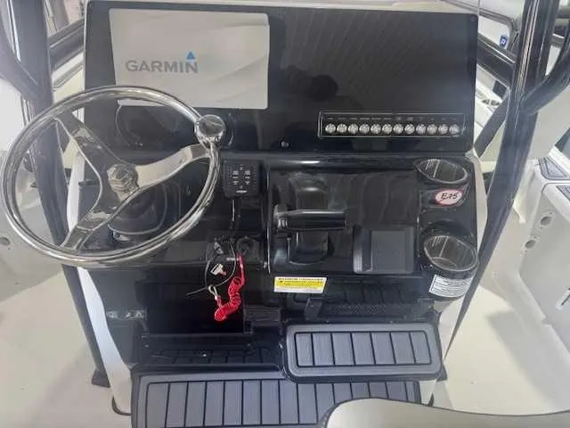 Slide: The Image of 2024 Tidewater 2210CB boat dashboard with Garmin display and steering wheel. - 5