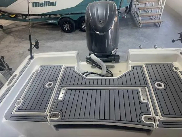 Slide: The Image of 2024 Tidewater 2210CB boat with Yamaha outboard motor in a garage setting. - 6