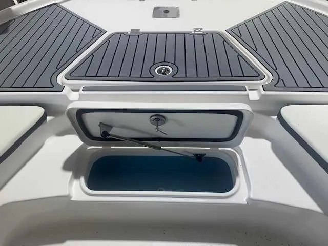 Slide: The Image of 2024 Tidewater 2210CB boat storage compartment with open hatch and sleek design. - 9