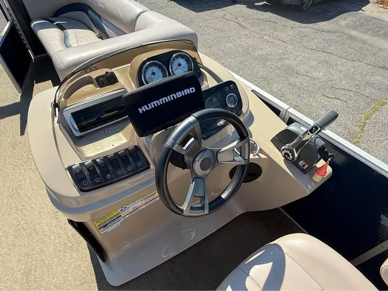 Slide: The Image of 2014 Godfrey 220 SL boat dashboard with steering wheel and Humminbird navigation system. - 10