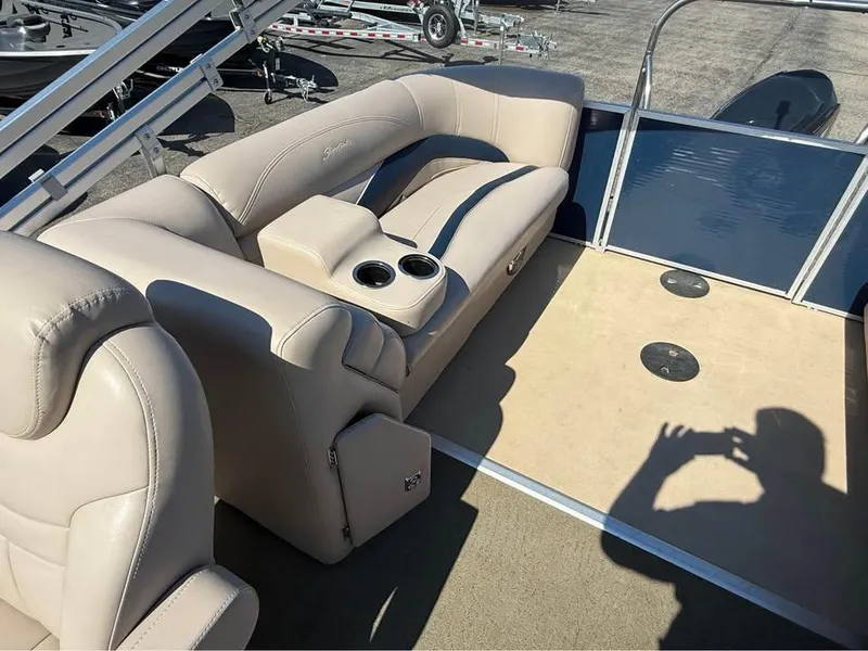 Slide: The Image of Interior of a 2014 Godfrey 220 SL boat with beige seating and cup holders. - 12