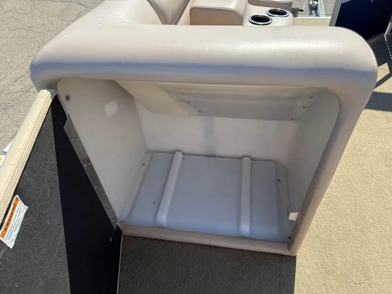 Slide: The Image of 2014 Godfrey 220 SL boat seat storage compartment with cup holders. - 14