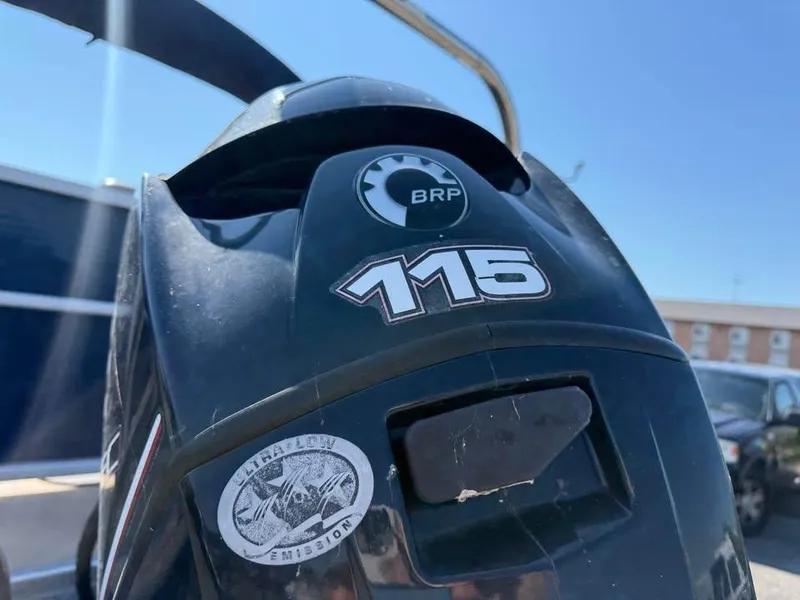 Slide: The Image of Outboard motor with BRP logo and "115" label on a Godfrey 220 SL, 2014 model. - 15