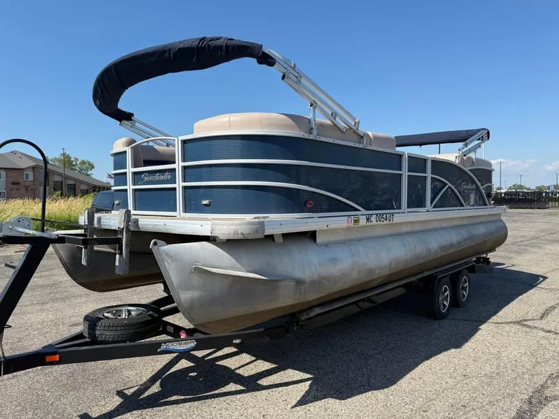 Slide: The Image of 2014 Godfrey 220 SL pontoon boat on trailer, parked outdoors. - 2