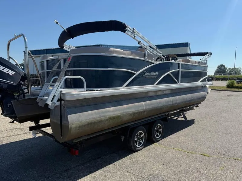 Slide: The Image of 2014 Godfrey 220 SL pontoon boat on trailer, parked outdoors under clear sky. - 3